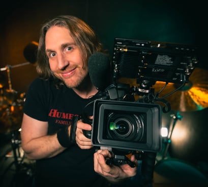 a man holding a camera and recording a video camera