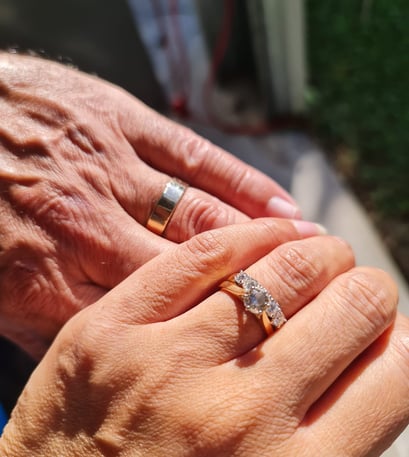 Image of Danny and Lana Weller, holding hands showing wedding rings, after their wedding, Brisbane