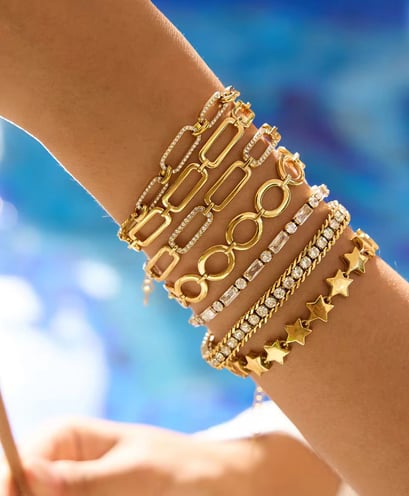 18 k gold plated Demi fine stacked bracelets which are water resistant and hypoallergenic.