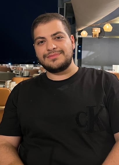 a man sitting at a table with a plate of food