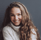 a woman with long hair and a white sweater