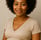 a pregnant woman with a short haircut and a short sleeved top