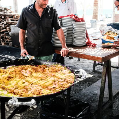 chefs plating a very big paella