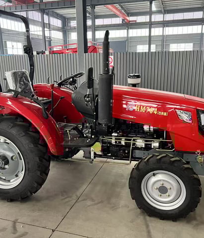 a red tractor with a large wheel on it