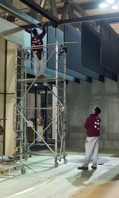 a man standing on a scaffold in a building