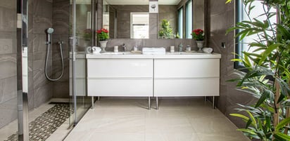 a bathroom with a large mirror and a shower