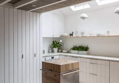 a kitchen with a wooden table and a dishwasher