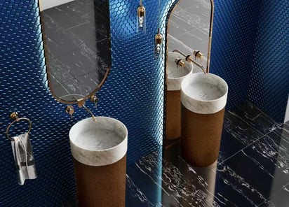 a bathroom with a blue tiled wall and a mirror