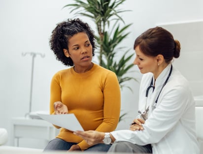 a doctor and a woman in a hospital room