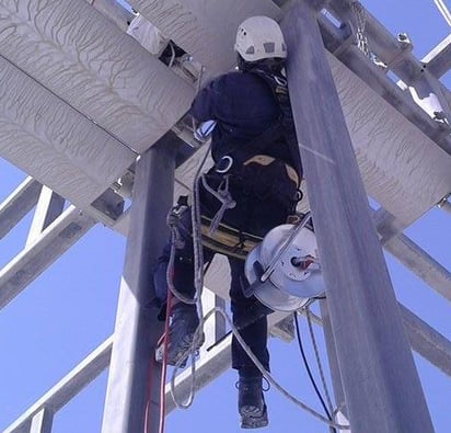 a man in a helmet and a helmet on a pole