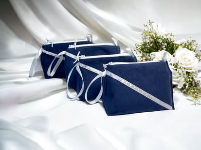 three bridesmaild bags of blue and white with flowers