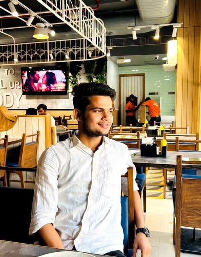 a man sitting at a table with a plate of food