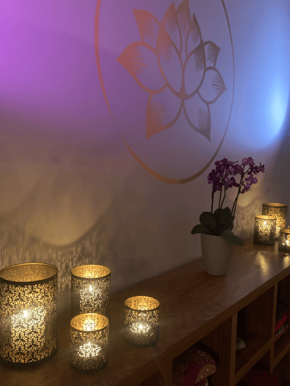 a table with candles and lit with purple light