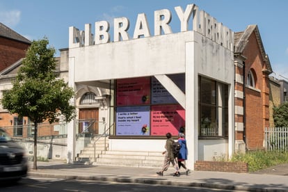 purple and pink poetry posters in library windows