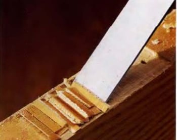 a knife sharpe knife cutting a piece of wood