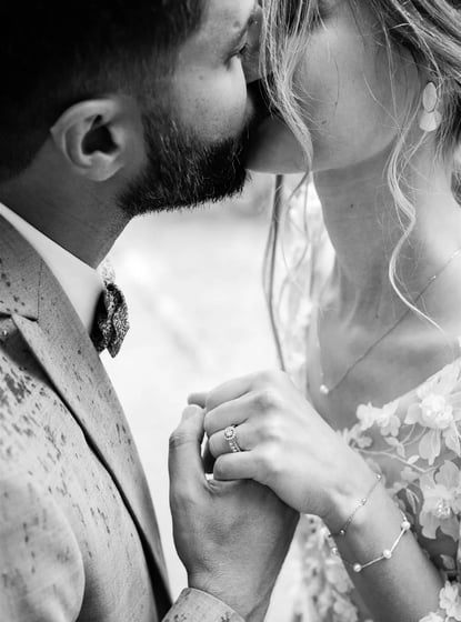 Editorial black and white fine art wedding photo of couple kissing in the rain in South of France