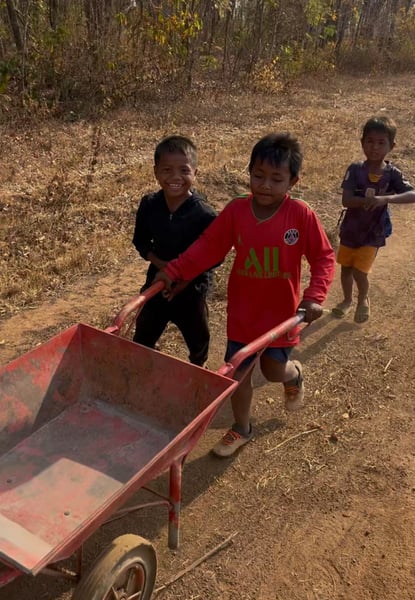 boys-pushing-wheelbarrow