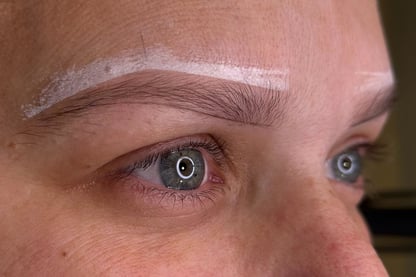 Woman after getting her eyebrows mapped by microblading master, ready for the procedure