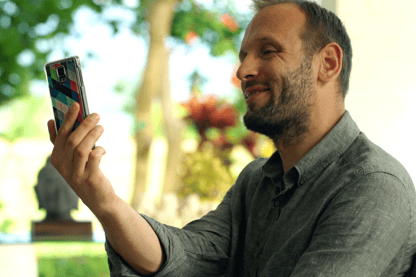 Man Videochatting On Phone and Showing Off His Garden