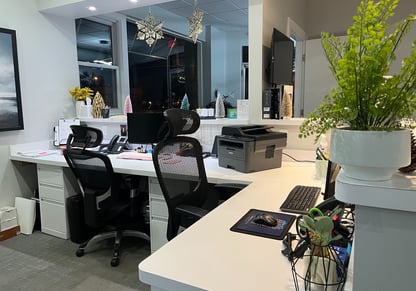 The desks inside a dental office's receptionist area.