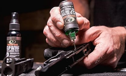 Mossy Oak Gun Oil being applied to a pistol