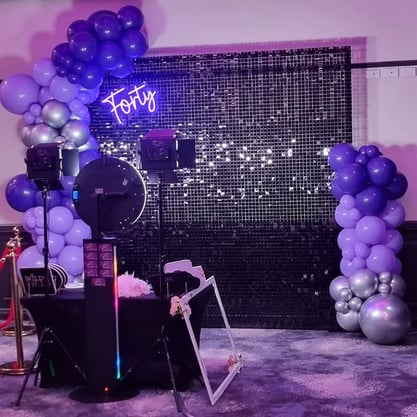 Pimped photo booth setup with black shimmer wall and balloon garland in Loganholme.