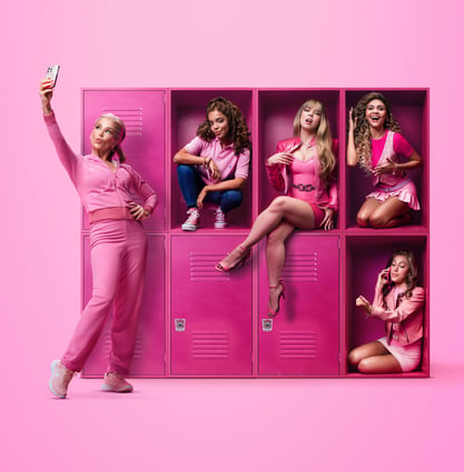 a woman in pink outfit standing in front of lockers with a cell phone