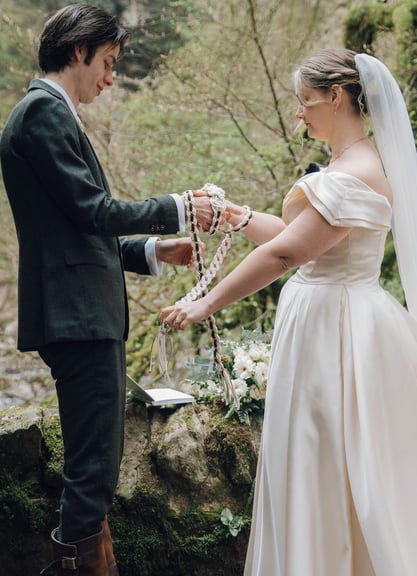 a man and woman holding hands and a rosary