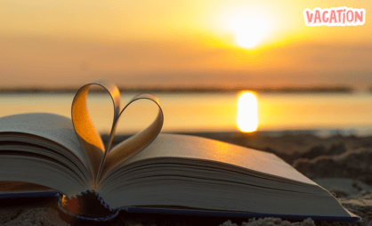 a book with a heart shaped bookmark on it during sunset