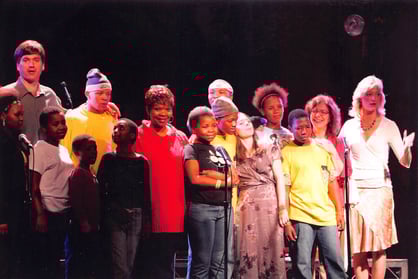 Angie Crouch, Love Hallie team, and Agape Orphans on stage at concert in Los Angeles