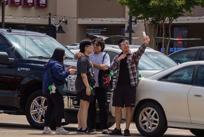 Four North Texas students play around and hang out in the 85C Bakery Cafe parking lot. Photo by Taylor Pleasant