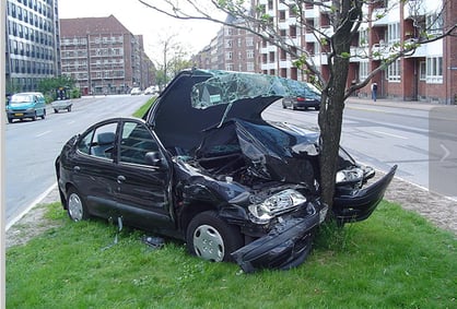 Wrecked vehicle with tree