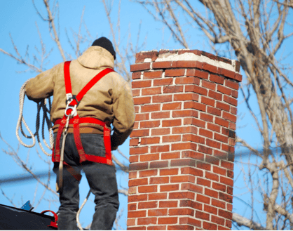 Man on roof chimney repair