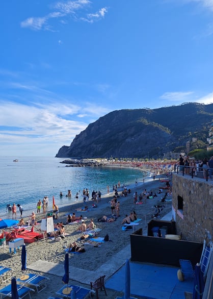 Sandy beach with lots of people in Monterosso Italy