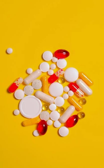 a variety of pills and pills on a yellow background