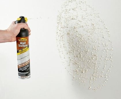 a person holding a spray canister of a spray canister