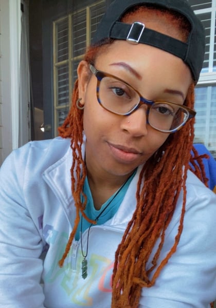 A woman with glasses smiling