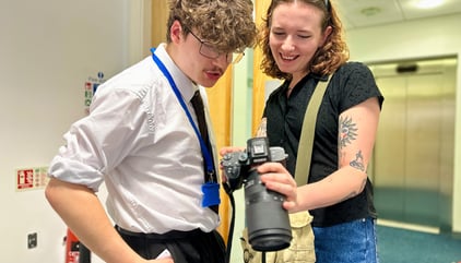 Our first assistant director showing a trainee some behind-the-scenes images on our short film time