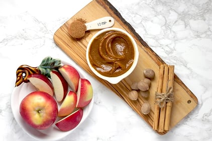 Apples with caramel on cutting board