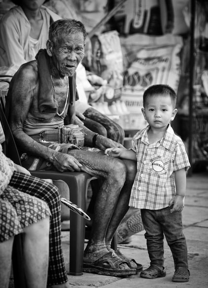 Old Thai man and his grandson - by Peter Pickering