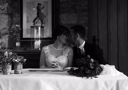 newly married couple sat close together with noses touching