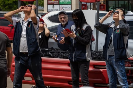 Workers at 99 Ranch Market stand outside the store to watch the solar eclipse. Photo by Taylor Pleasant