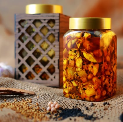 a jar of dried nuts in a jar with a spoon and spoon