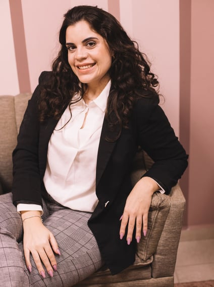 a woman in a suit and tie dyes a white shirt