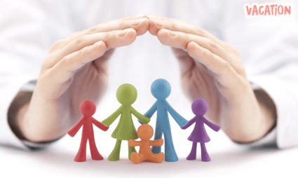 a person holding a small group of colorful paper cutouts