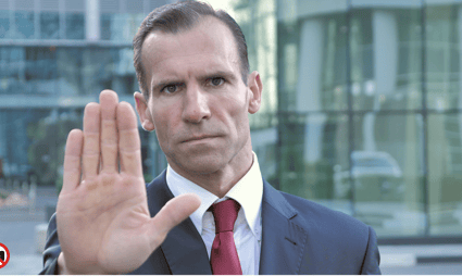 a man in a suit and tie is holding his hand up to the camera