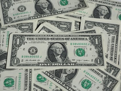a pile of money bills and dollars bills