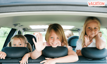 three girls sitting in the back of a car