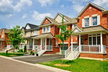 a row of houses with a driveway