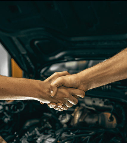 Our skilled mechanics shaking hands, symbolizing trust and professionalism in every service